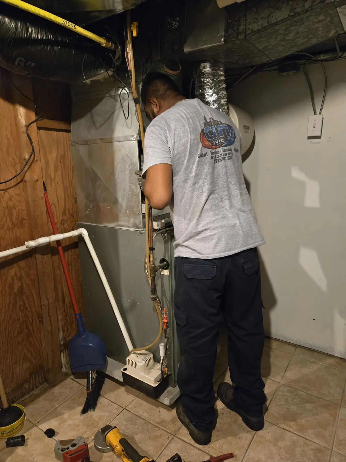 CITI HVAC technician installing new AC system components — Windsor ON