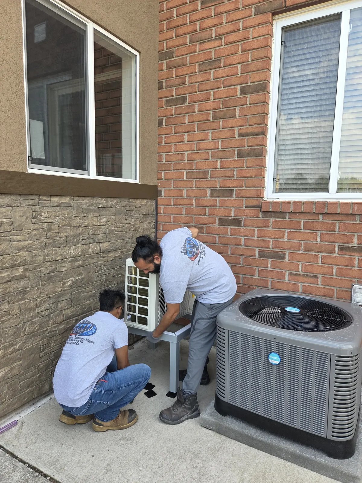 CITI HVAC technicians setting outdoor heat pump stand for mini-split — South Windsor ON