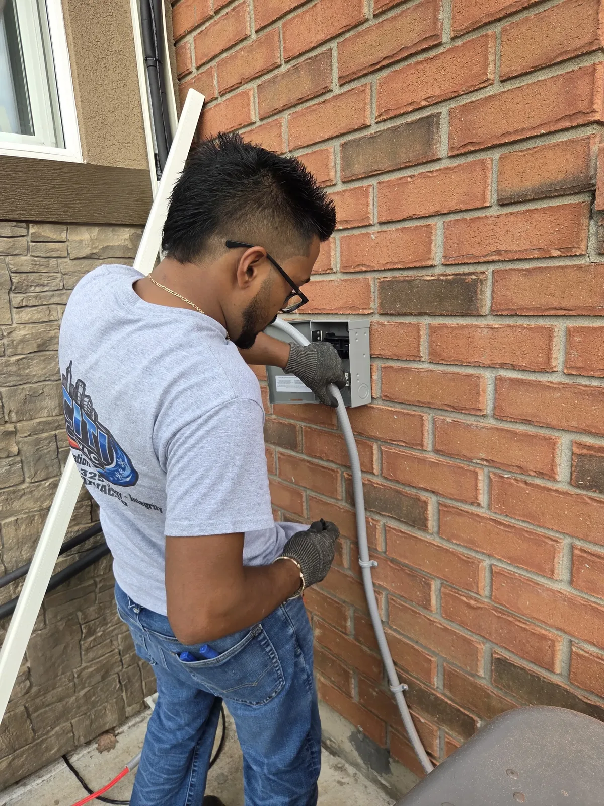 CITI HVAC technician wiring the dedicated disconnect for mini-split heat pump outdoor unit — South Windsor ON