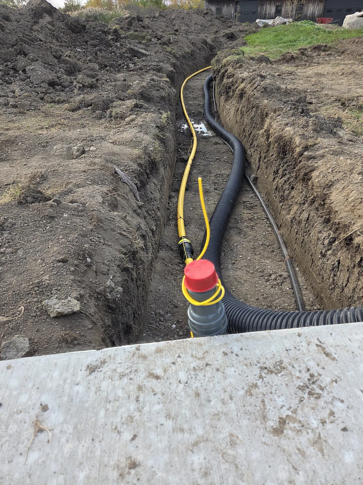 Open trench with yellow gas line run to generator pad — Essex ON