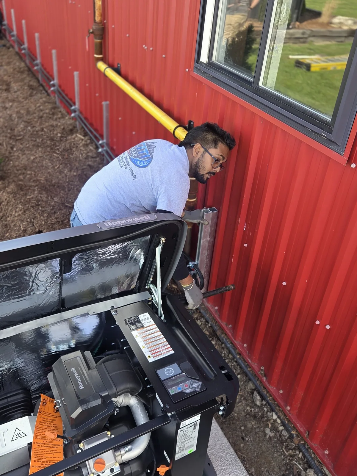CITI HVAC technician connecting gas line to 22kW Honeywell standby generator — Essex ON