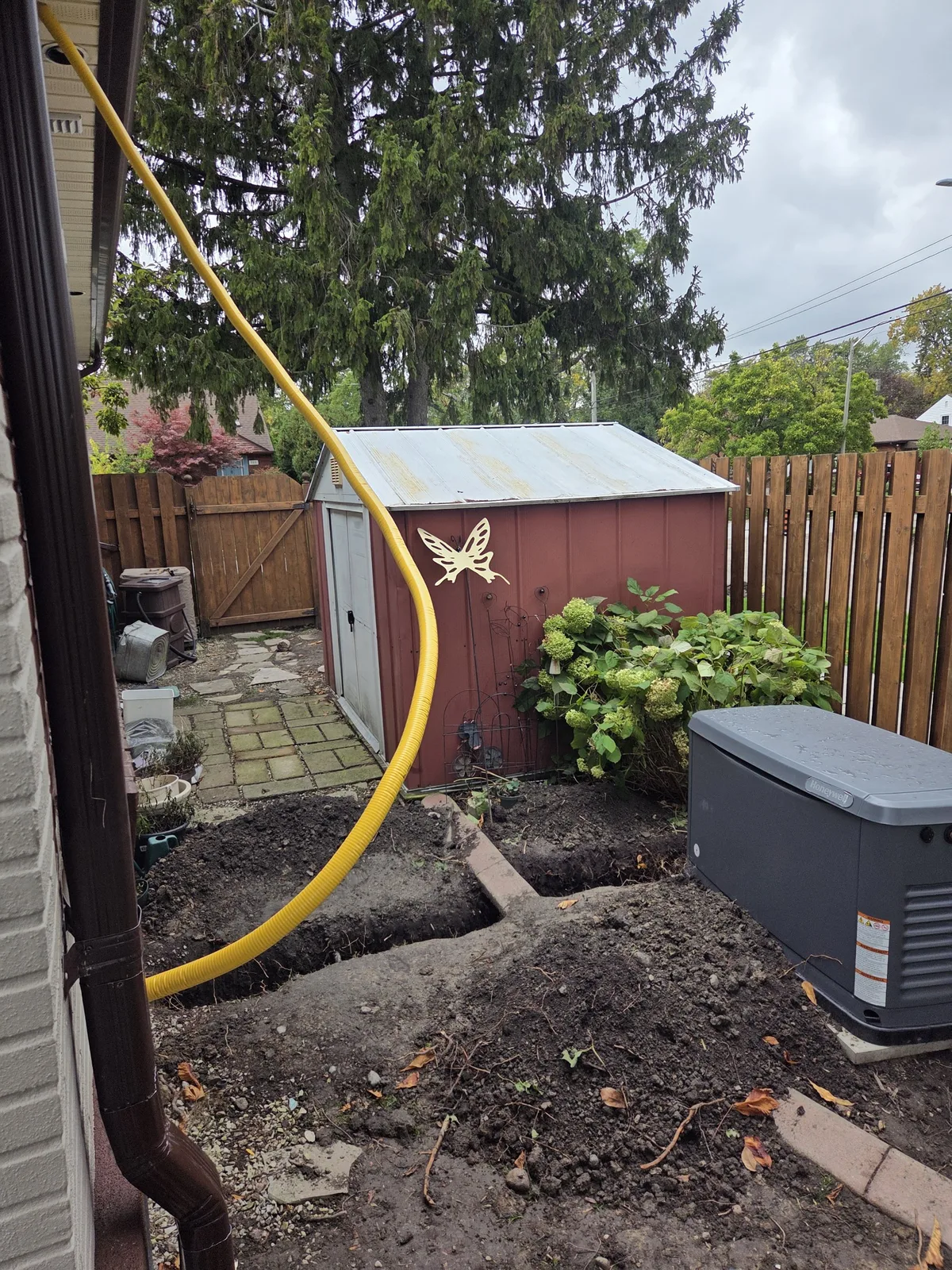 Yellow gas line routed in open trench to generator location — Tecumseh ON