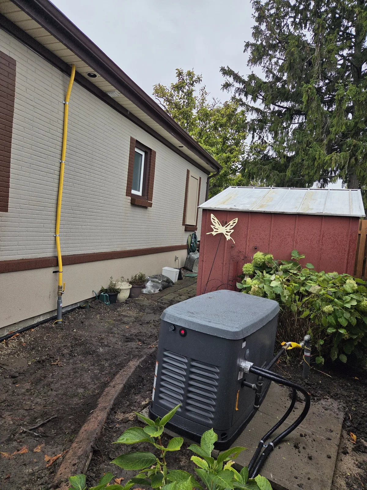 Completed 22kW standby generator installation with gas line run up the wall — Tecumseh ON