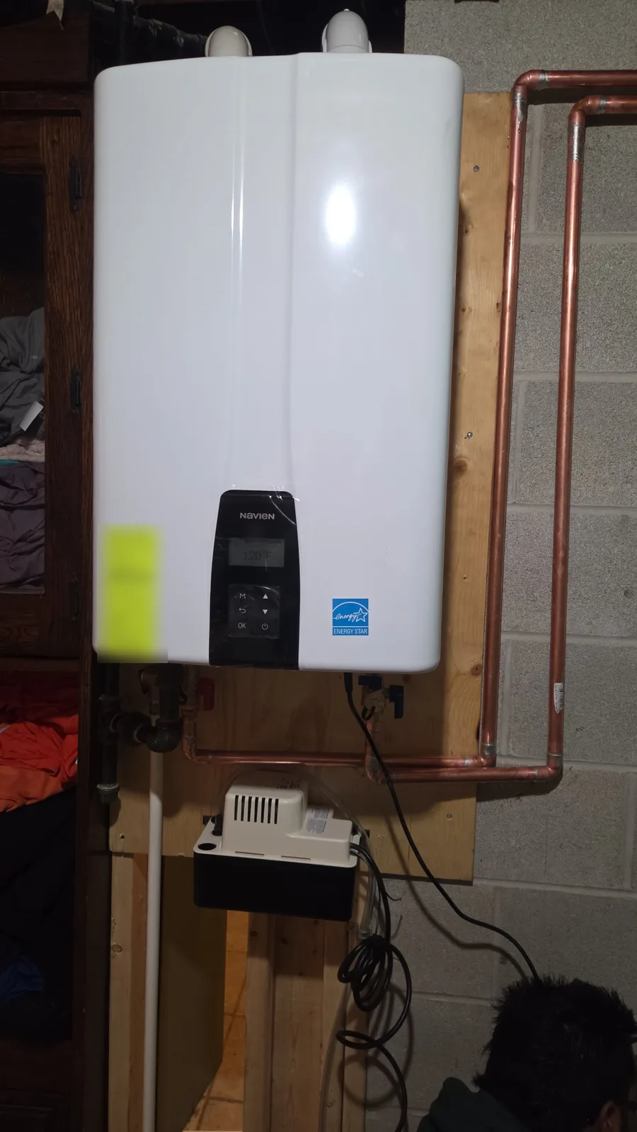 Navien tankless water heater close-up with copper supply and return lines