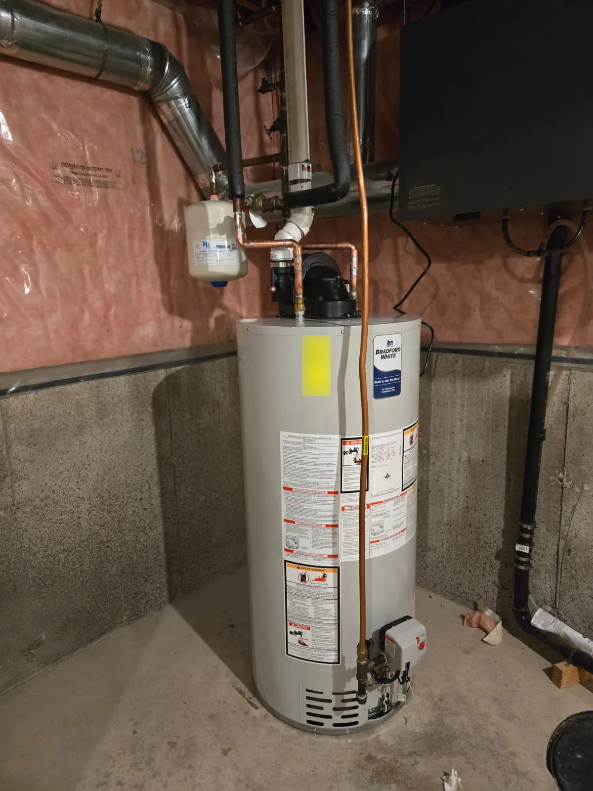 Completed power vent gas tank water heater installation with expansion tank and copper lines