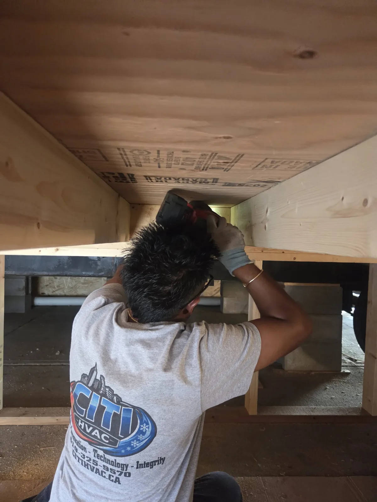 CITI HVAC technician drilling under trailer — Chatham ON
