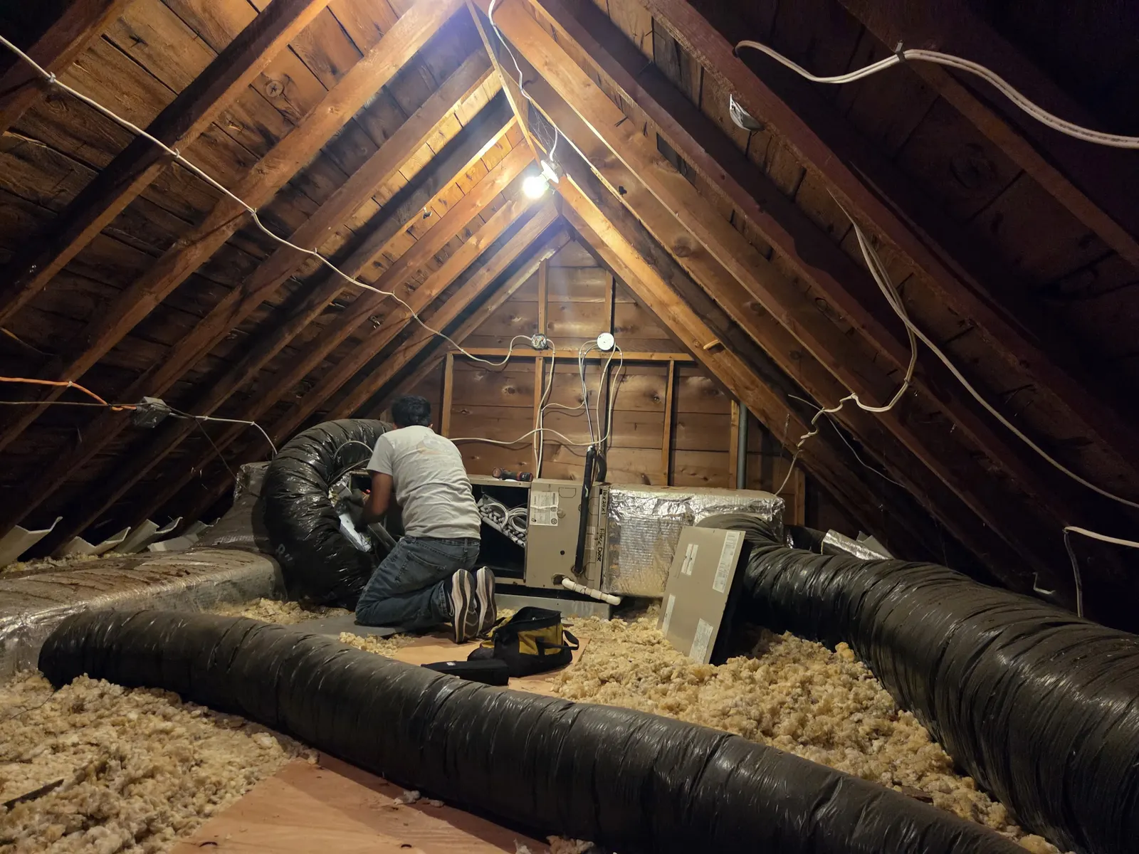 CITI HVAC technician inspecting attic air handler and ductwork during diagnostic visit — South Windsor ON
