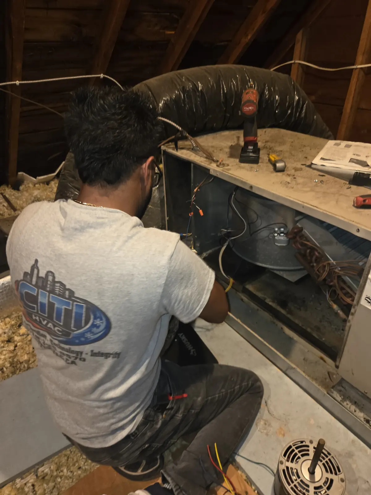 CITI HVAC technician diagnosing attic HVAC system, close detail — South Windsor ON